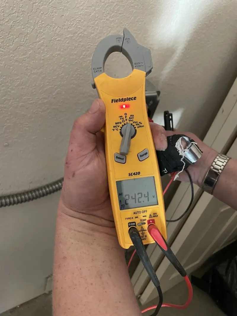 Voltage testing with clamp meter during Recessed Lighting Installation in Niwot